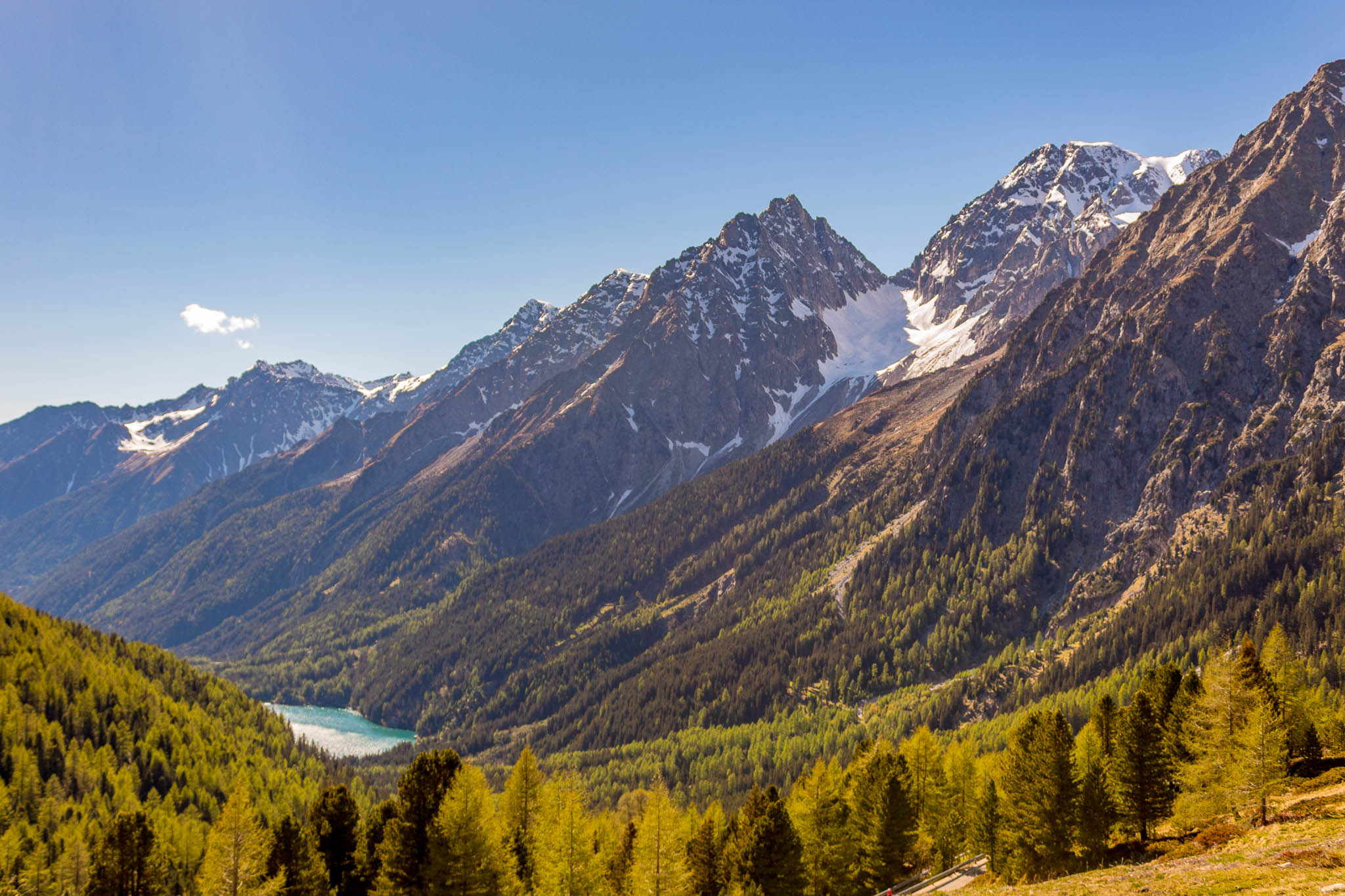 Standing at the border between Austria and Italy on Staller Sattel, looking into Italy at Antholzer See. The road leading up to the pass is single lane and quite twisty