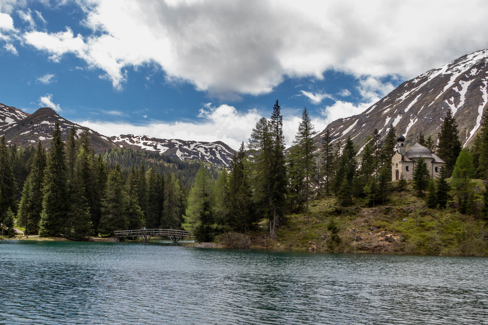 I little church in the middle of the lake, surrounded by majestic mountains, I always enjoy spending time at this lake.  But who would have expected to see that much snow in late may up there?