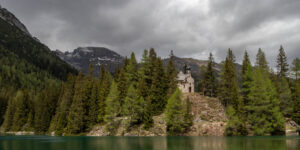 dark clouds up in the sky, but the little church is nicely lit up.