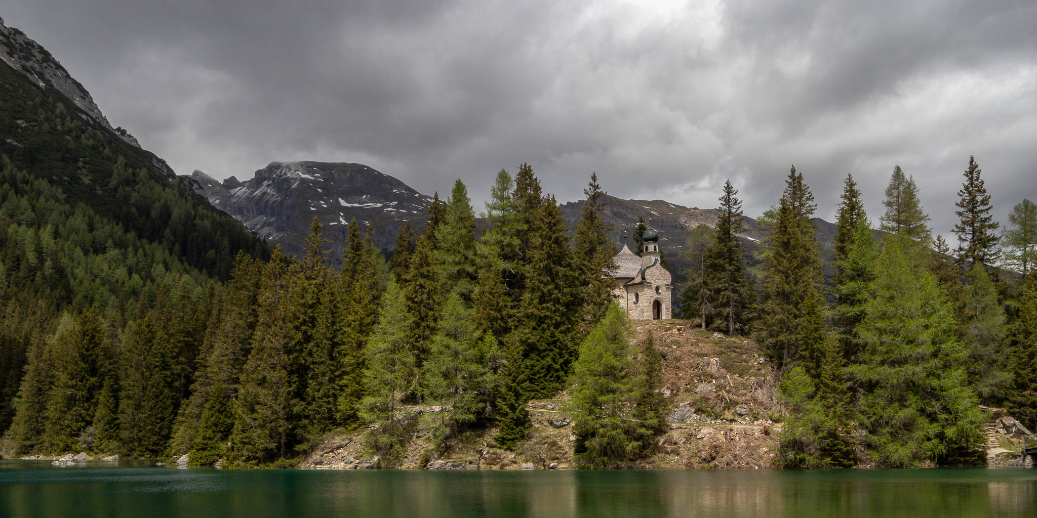 dark clouds up in the sky, but the little church is nicely lit up.