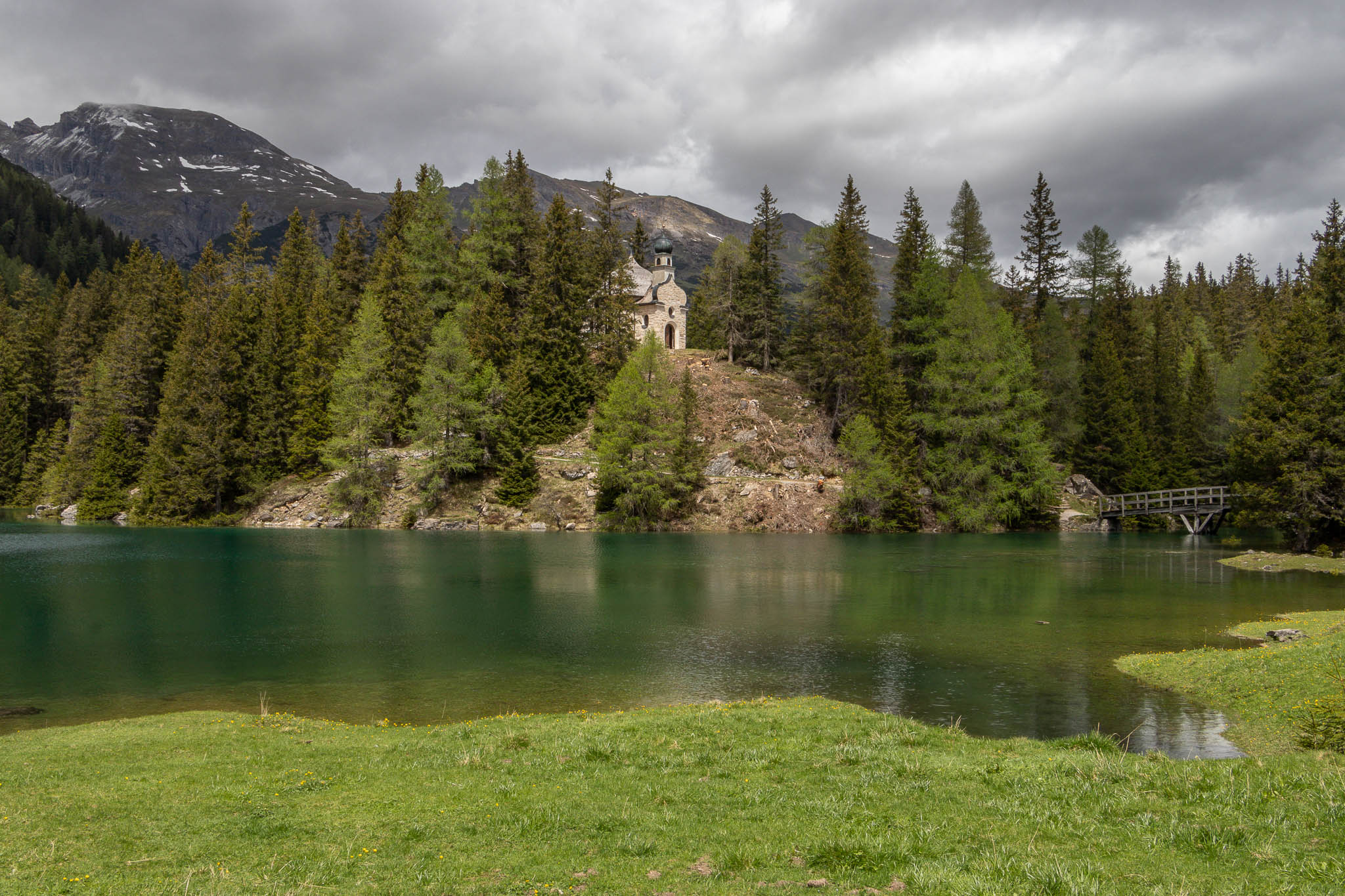 As the grass is getting flooded by the snow melt and the lake is growing in size the bridge gives us safe access to the church.