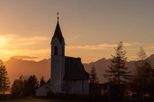 the church standing tall among the pine trees with the mountains behind it makes me connect to the beauty around us